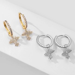 Detail showing gold and silver airplane hoop earrings with pavé micro-set cubic zirconia
