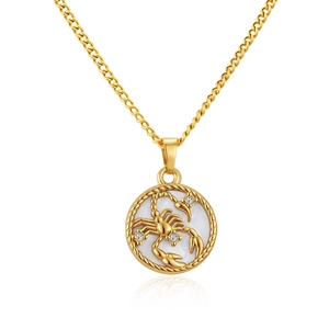 Macro detail of Scorpio zodiac pendant with mother of pearl inlay and gold finish necklace