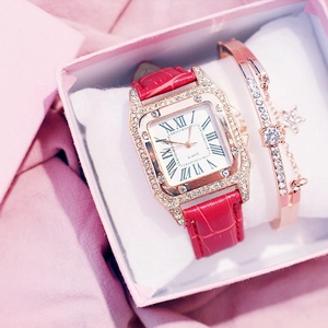 Detailed view of rose gold tonneau watch and star bracelet in a velvet gift box