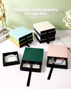 Detailed top view of pastel-colored drawer jewelry boxes with elegant pull tabs and film display