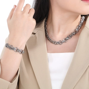 Mens silver stainless steel link chain necklace and bracelet set worn by a model