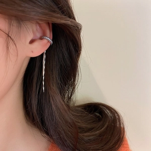 Detailed view of silver zircon C-shape ear cuff with elegant long tassel chain fringe