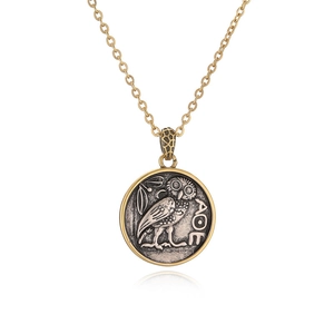 Punk style owl pendant necklace with silver Greek coin on gold chain over white background