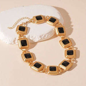 Detail of vintage gold-tone chain necklace with square black enamel geometric links