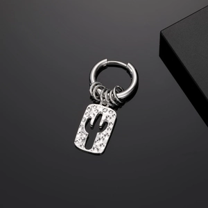 Detail of silver cactus hollow earrings with hammered texture and industrial design