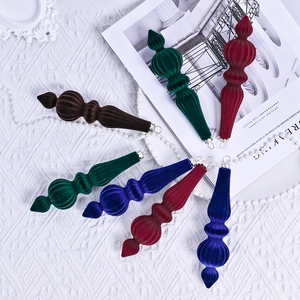 Conical velvet Christmas balls with ribbed texture in green, wine red, and blue tones