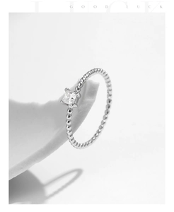 Macro shot of S925 sterling silver beaded ring with single square moissanite stone