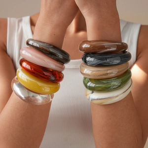 Close-up of colorful chunky acrylic bangles with marble texture and high gloss finish