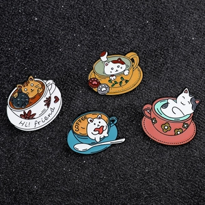 Detail view of 4 cute enamel cat and coffee cup brooches on a black glitter background