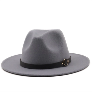 Detailed macro view of gray wool fedora hat with black decorative band and gold metal ring