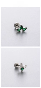 Macro detail of crown butterfly ear studs with emerald green cubic zirconia stones