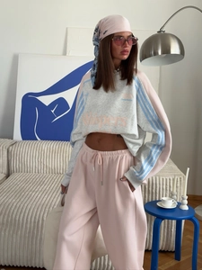 Detailed view of women's retro sweatshirt and pink sweatpants with stylish headscarf set