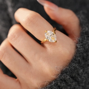 Macro shot of 18k gold plated oval zirconia ring showing minimalist four-prong setting