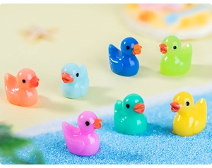Colorful resin mini ducks shown on a sandy beach scene for DIY micro landscape decor
