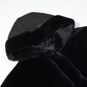 Detail of black faux fur hood with quilted lining on a loose jacket for women