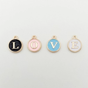 Detailed view of round metal LOVE letter charms with colorful enamel for jewelry making
