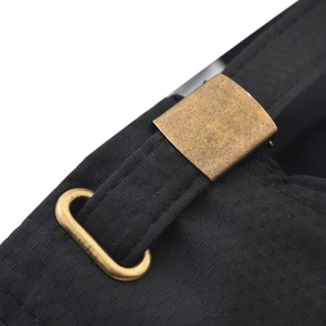 Detail of adjustable antique bronze metal buckle on black quick-dry outdoor cap