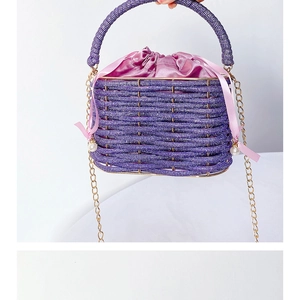 Detail of purple rhinestone woven bucket bag with satin drawstring and pearl strap