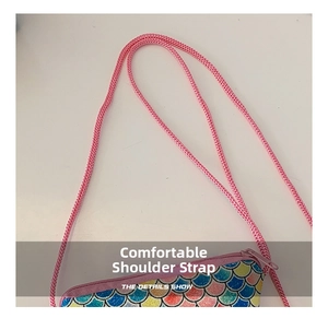 Detail shot of comfort pink woven shoulder strap and colorful sequin mermaid scales bag