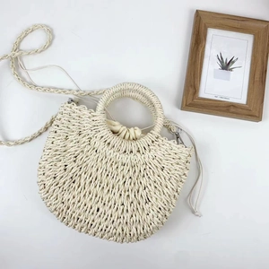 Handmade woven straw crossbody bag in cream white with semi-circle design and top handle