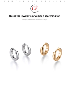 Detailed view of silver and gold polished stainless steel hoop earrings with snap closure