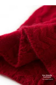 Macro detail of red eco-cashmere knit hat showing soft texture and cable knit patterns