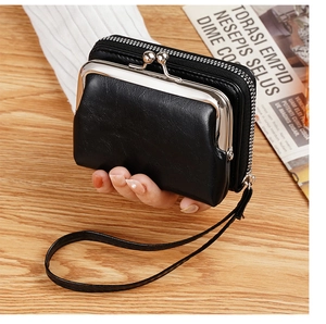 Close-up of a vintage black PU leather coin purse with metal clasp and wrist strap