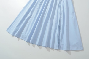 Detail of light blue French retro dress showing pleated hem and premium cotton fabric texture