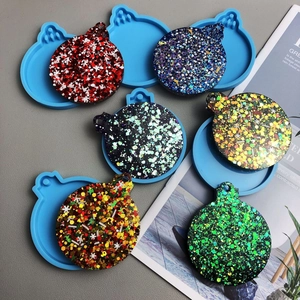 Detailed view of DIY Christmas resin molds with glitter snowflake pendants for keychains