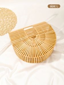 Detail of handcrafted semi-circle bamboo handbag showing natural texture and size L label