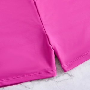 Detail of rose red high-elastic fabric with precision double-needle hem stitching