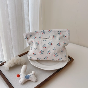 Detail of floral makeup bag with simple wish label and textured cotton fabric