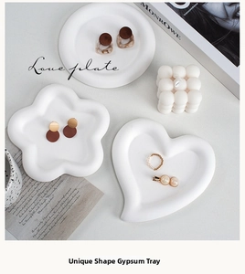 Macro shot of white heart and flower shaped plaster jewelry display trays for photography