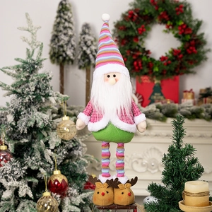 Detail of plush Santa doll with rainbow hat and reindeer slippers by a festive fireplace