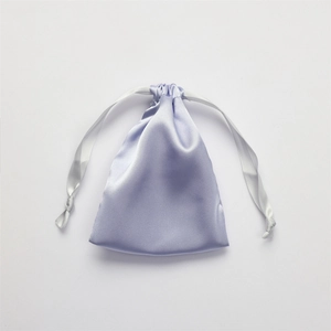 Pale purple satin drawstring storage pouch with a white ribbon tie for sleep eye mask set