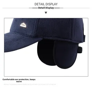 Close-up of winter baseball cap showing navy herringbone texture and ear protection