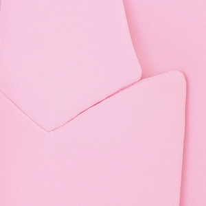 Detail of soft pink suit lapel showing high-quality woven texture and clean-cut edges
