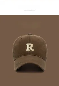 Macro detail of coffee brown cotton baseball cap with beige 3D towel embroidered R letter