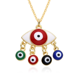 Detailed close-up of golden evil eye pendant necklace with colorful micro-set charms