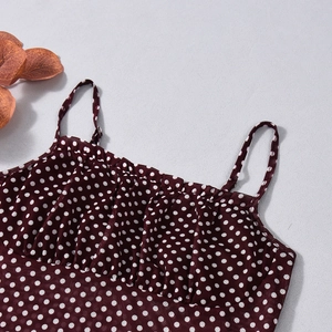 Detail of burgundy mesh camisole with white polka dots and delicate ruffled neckline