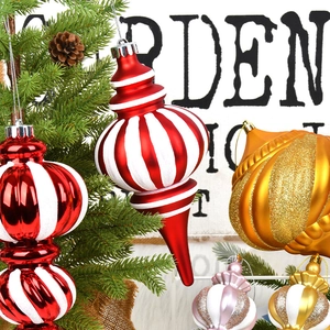Red and white striped Christmas baubles in onion and waterdrop shapes on a tree