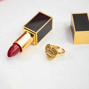 Macro detail of golden heart open ring with hollow design and embossed texture
