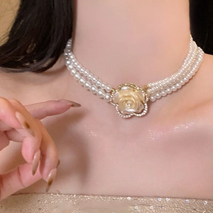 Three-layer pearl necklace featuring a detailed resin flower pendant with rhinestones