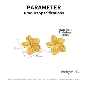 Detail of 30mm gold stainless steel floral earrings with brushed metal texture and beads