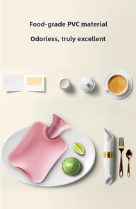 Pink food-grade PVC hot water bottle with non-slip texture in a cozy setting