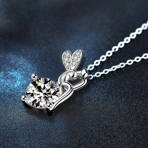 Moissanite 925 sterling silver fairy necklace with rabbit ear pendant on dark background
