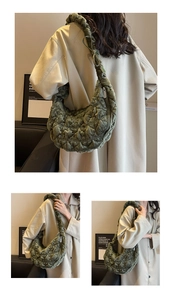 Detail view of dark green quilted cloud bag with velvet texture and adjustable shoulder strap