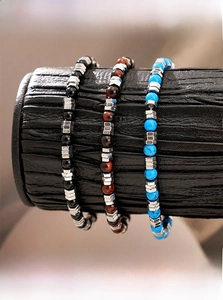 Close-up of beaded bracelets with tiger eye, onyx and turquoise stones for men