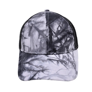 Detail of black and white tie-dye marble pattern on a mesh back trucker baseball cap