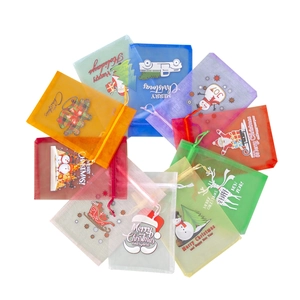 Macro detail of various organza Christmas gift bags with colorful festive patterns